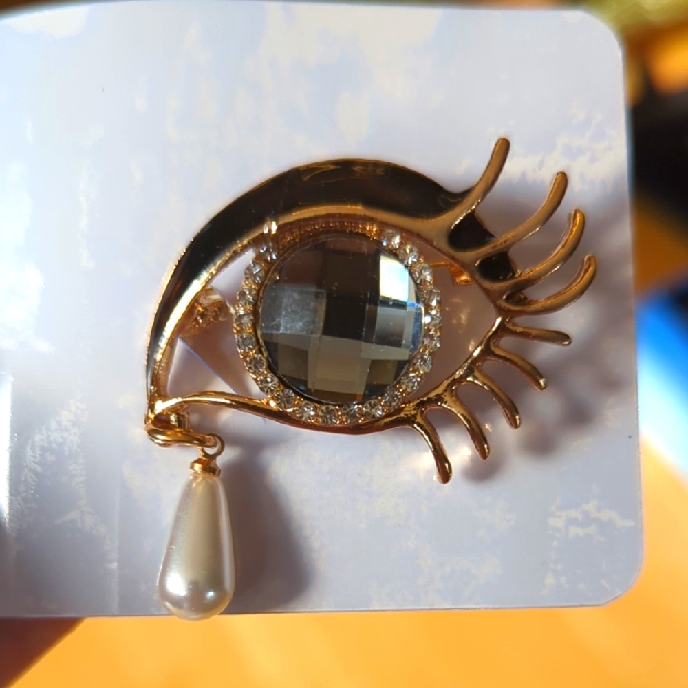 Gold and White Eye Brooch with Dramatic Lashes and Teardrop Pendant